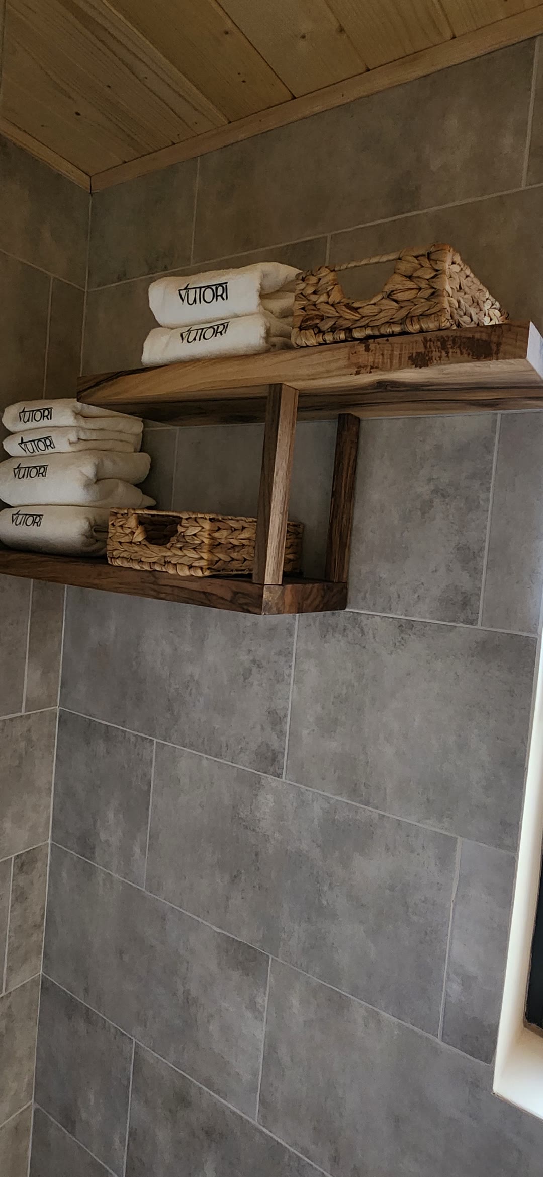 Yutori towels and woven baskets on a walnut shelf