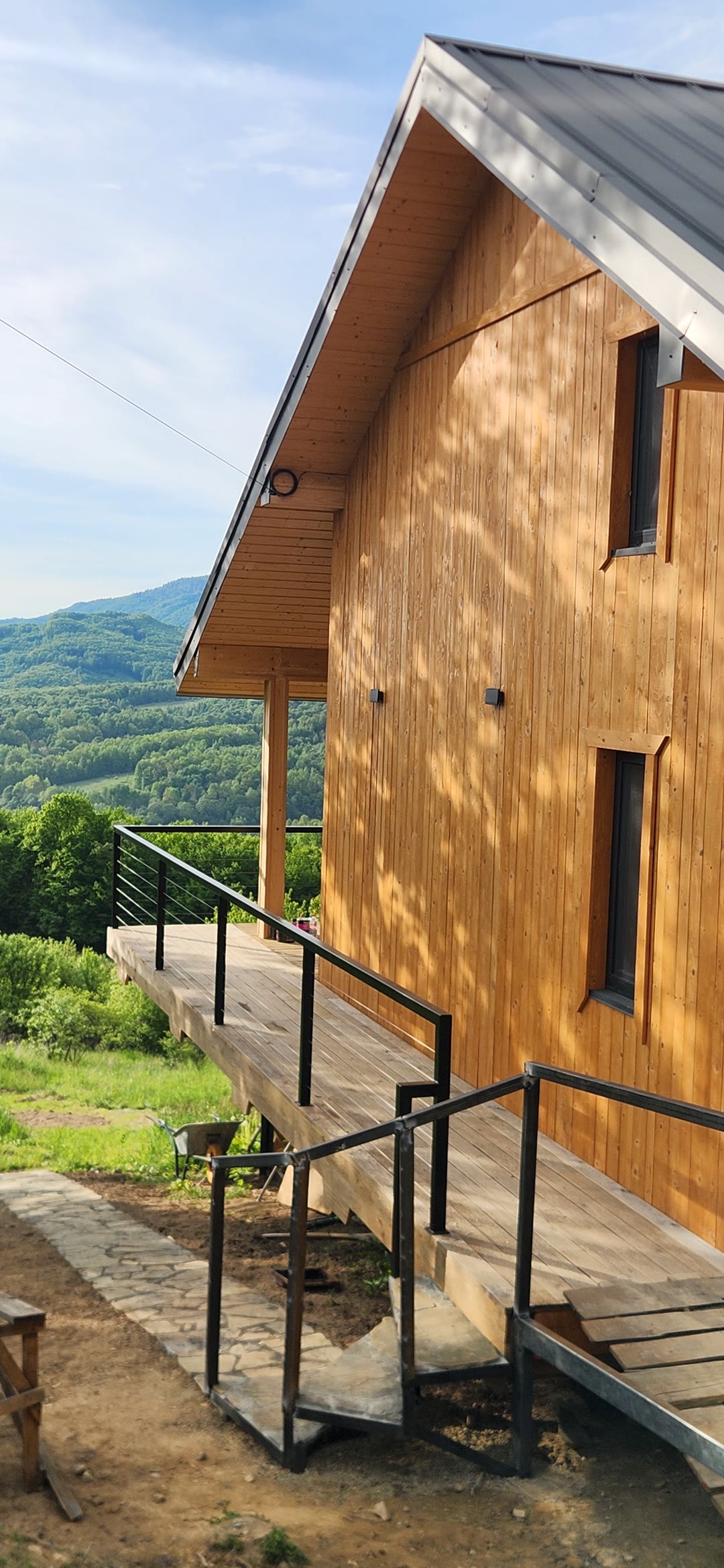 The timber façade of Yutori, steps to the terrace and mountains behind